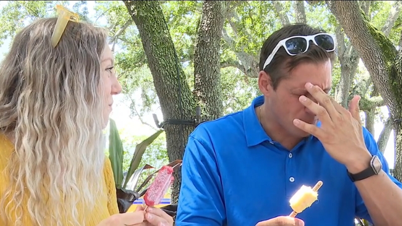 A Person Experiencing Brain Freeze While Eating a Popsicle